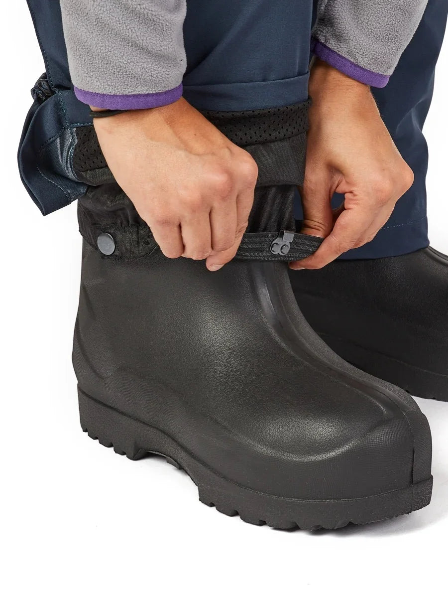 Adjusting waterproof boot gaiter on rugged black rubber boot for ice fishing or wet weather