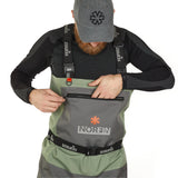 Man wearing Norfin waterproof waders with front pocket and adjustable straps for outdoor fishing adventures