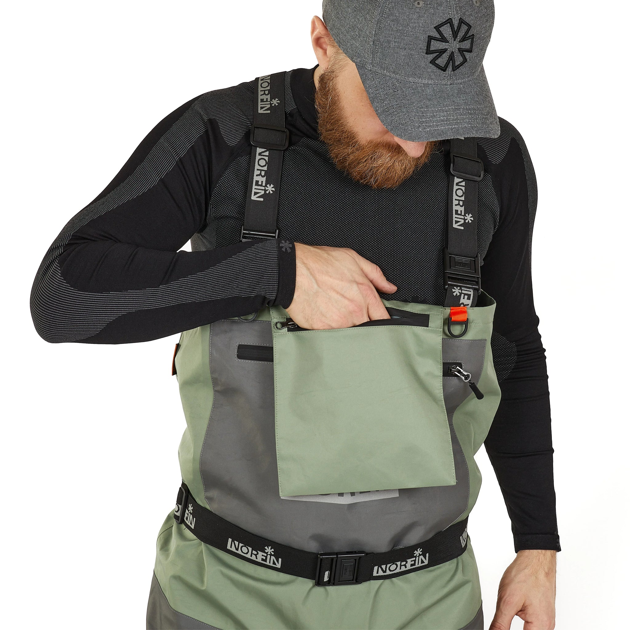 Man wearing olive and gray waterproof waders with chest pocket, ideal for ice fishing or outdoor adventures.